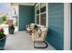 Cozy front porch with wicker chairs, pillows, and potted plants, creating a relaxing outdoor space at 2020 Cotton Barn Ct, Wendell, NC 27591