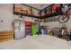 Organized garage space with ample storage, including overhead racks, cabinets, and tool chests at 2020 Cotton Barn Ct, Wendell, NC 27591
