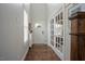 Bright hallway with hardwood floors, French doors, and a view of the home's entryway at 2020 Cotton Barn Ct, Wendell, NC 27591