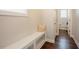 Hallway with storage bench seat, hardwood floors, and easy access to other areas of the home at 2020 Cotton Barn Ct, Wendell, NC 27591