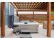 Relaxing hot tub under a covered pergola with outdoor seating at 2020 Cotton Barn Ct, Wendell, NC 27591