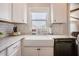 Clean kitchen featuring granite countertops, a white farmhouse sink, and tiled backsplash at 2020 Cotton Barn Ct, Wendell, NC 27591