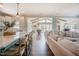 Open-concept living room features a kitchen island, dark wood floors, and backyard views at 2020 Cotton Barn Ct, Wendell, NC 27591