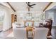 Bright living room with exposed beams, ceiling fan, hardwood floors, and ample seating at 2020 Cotton Barn Ct, Wendell, NC 27591