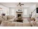 Comfortable living room featuring a fireplace, large sofa, and wood-look flooring at 2020 Cotton Barn Ct, Wendell, NC 27591