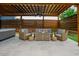 Outdoor seating area with stylish wicker furniture, a ceiling fan and a hot tub under an aluminum covered pergola at 2020 Cotton Barn Ct, Wendell, NC 27591