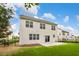 Well-maintained backyard featuring a walkout concrete patio, lush green grass, and a sleek black fence at 213 Florence Dr, Clayton, NC 27527