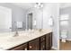 Bright bathroom with double sinks, dark wood cabinets, and a separate toilet room at 213 Florence Dr, Clayton, NC 27527