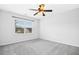 Empty bedroom featuring neutral carpet, a window, and a ceiling fan providing natural light at 213 Florence Dr, Clayton, NC 27527