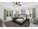 Comfortable bedroom with tray ceiling, ceiling fan, lots of light and a decorative rug at 213 Florence Dr, Clayton, NC 27527