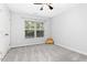 Empty bedroom with a window, carpet and a ceiling fan plus a few throw pillows at 213 Florence Dr, Clayton, NC 27527