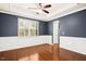 Spacious dining room featuring hardwood floors, elegant trim, a ceiling fan, and a large window for ample natural light at 213 Florence Dr, Clayton, NC 27527