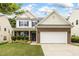 Charming two-story home with brick accents, white siding, manicured landscaping, and an attached two-car garage at 213 Florence Dr, Clayton, NC 27527