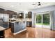 Modern kitchen with stainless steel appliances, dark wood cabinets, a center island, and sliding glass doors to the backyard at 213 Florence Dr, Clayton, NC 27527
