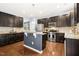 Modern kitchen featuring stainless steel appliances, dark wood cabinets, granite countertops, and a center island at 213 Florence Dr, Clayton, NC 27527
