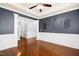 Spacious living room featuring hardwood floors, elegant trim, grey walls, and white columns at 213 Florence Dr, Clayton, NC 27527