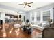 Inviting living room flows to dining area and kitchen with wood floors and lots of natural light at 213 Florence Dr, Clayton, NC 27527