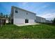 Home with a large, green backyard and sliding glass doors leading from the house at 221 Hallow Oak St, Spring Lake, NC 28390