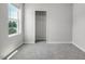 Bright bedroom with neutral carpeting, a window with view, and a closet with shelves at 221 Hallow Oak St, Spring Lake, NC 28390