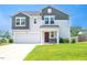 Charming two-story home features a well-maintained front yard and attached garage for modern suburban living at 221 Hallow Oak St, Spring Lake, NC 28390