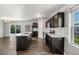 Modern kitchen featuring stainless steel appliances, dark cabinets, and an island with a sink at 221 Hallow Oak St, Spring Lake, NC 28390