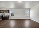 Bright living room features dark wood-style flooring and windows for natural light throughout the home at 221 Hallow Oak St, Spring Lake, NC 28390