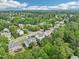 A high-angle shot showcasing the neighborhood's layout amidst a canopy of trees at 2317 Colony Woods Dr, Apex, NC 27523