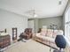 Spacious basement area featuring comfortable seating, ceiling fan, and exercise equipment at 2317 Colony Woods Dr, Apex, NC 27523
