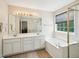 Bright bathroom with double sinks, a soaking tub, and a separate glass-enclosed shower at 2317 Colony Woods Dr, Apex, NC 27523
