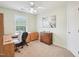 Bedroom with neutral walls, ceiling fan, carpeted floor, a wooden desk, and a sunlit window at 2317 Colony Woods Dr, Apex, NC 27523