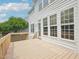 Spacious outdoor deck with wood railings, offering a view of the well-maintained backyard at 2317 Colony Woods Dr, Apex, NC 27523