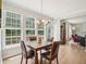 The dining area is bright with natural light from big windows and wood floors at 2317 Colony Woods Dr, Apex, NC 27523