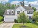 Two-story home with white siding, black shutters, dormer windows and a 2-car garage at 2317 Colony Woods Dr, Apex, NC 27523