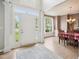 Open foyer with hardwood floors, leading into a dining room with chandelier and wainscoting at 2317 Colony Woods Dr, Apex, NC 27523