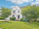 Inviting two-story home featuring a lush front lawn with mature trees and well-maintained landscaping at 2317 Colony Woods Dr, Apex, NC 27523