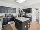Spacious kitchen features black appliances, granite countertops, a central island, and ample cabinet space at 2317 Colony Woods Dr, Apex, NC 27523