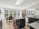 An eat-in kitchen has granite countertops, an island with seating, and big windows for natural light at 2317 Colony Woods Dr, Apex, NC 27523