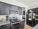 This kitchen is equipped with sleek black appliances, including a range, microwave, and refrigerator at 2317 Colony Woods Dr, Apex, NC 27523