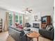 Bright living room with a fireplace, large windows, and comfortable seating at 2317 Colony Woods Dr, Apex, NC 27523