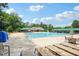 Large community pool featuring lounge chairs, umbrellas, and a nearby picnic area at 2317 Colony Woods Dr, Apex, NC 27523