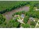 Aerial view of a lakefront home among lush trees and beautiful scenery at 248 Ashford Dr, Pittsboro, NC 27312