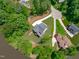 Aerial view of a house surrounded by trees in a neighborhood near the lake at 248 Ashford Dr, Pittsboro, NC 27312