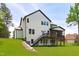 Expansive backyard with deck, stairs, and green lawn at 248 Ashford Dr, Pittsboro, NC 27312