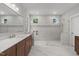 Sleek bathroom featuring marble tiling, glass shower, and vanity at 248 Ashford Dr, Pittsboro, NC 27312