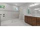 Bathroom featuring marble tiling, glass shower, and vanity at 248 Ashford Dr, Pittsboro, NC 27312