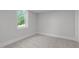 Bedroom with neutral carpet, light-grey walls, white trim and a window with a pleasant outdoor view at 248 Ashford Dr, Pittsboro, NC 27312