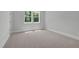 Bright bedroom with neutral carpet, white trim, and double window with backyard view at 248 Ashford Dr, Pittsboro, NC 27312