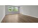 Bedroom featuring wood-look floors, large windows, and natural light at 248 Ashford Dr, Pittsboro, NC 27312