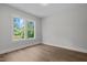 Bedroom featuring hardwood floors, base trim, and a window with outdoor views at 248 Ashford Dr, Pittsboro, NC 27312