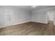 Open bedroom area featuring wood-look floors and ample lighting at 248 Ashford Dr, Pittsboro, NC 27312